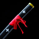 Black painted wood saya with white cross motifs and red cord bow
