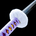 Close-up of fluffy white guard, purple handle wrap and blade collar