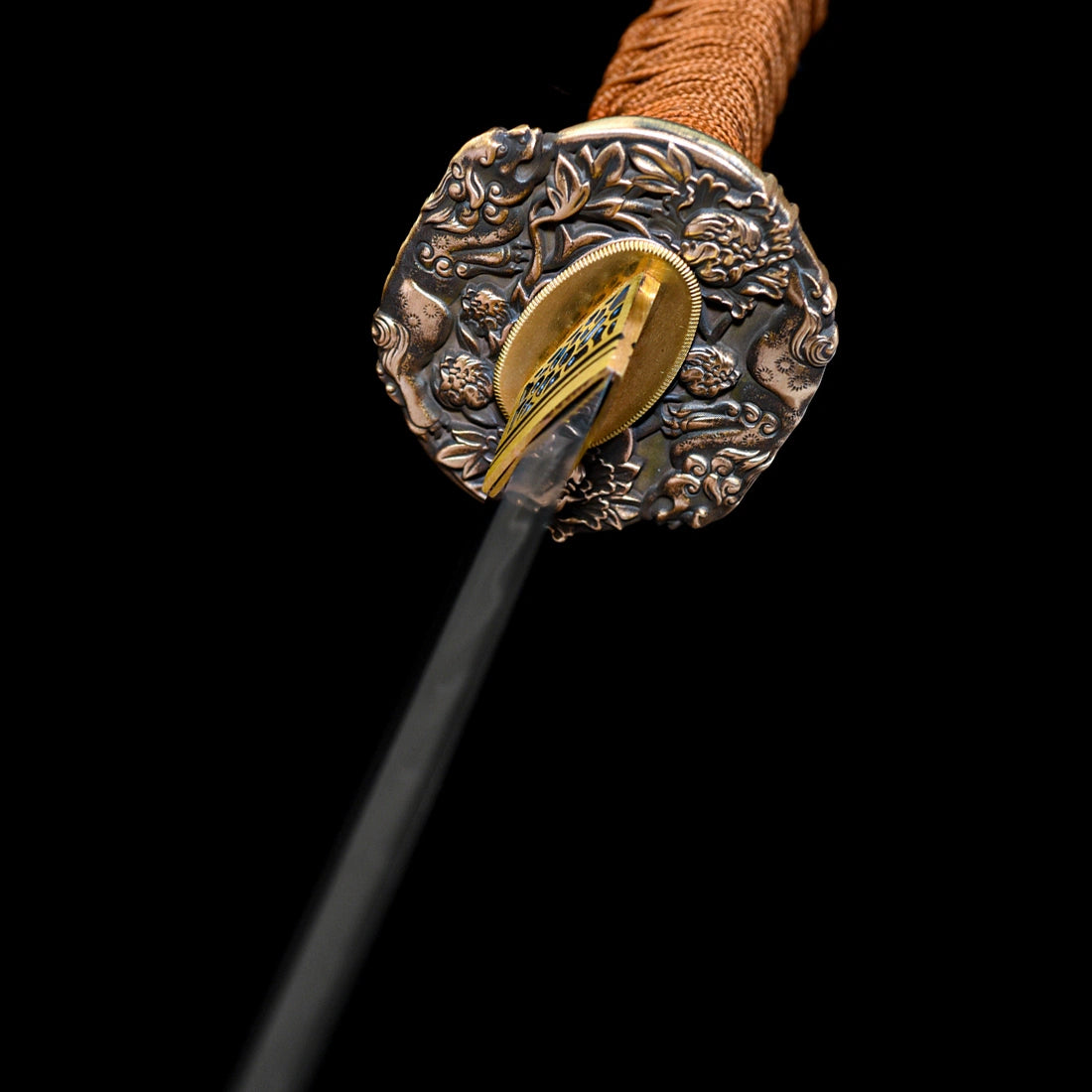 Top perspective of hand-carved pure copper floral Tsuba guard, gold Habaki collar, and brown wrapped Tsuka handle on Dragonheir Tachi