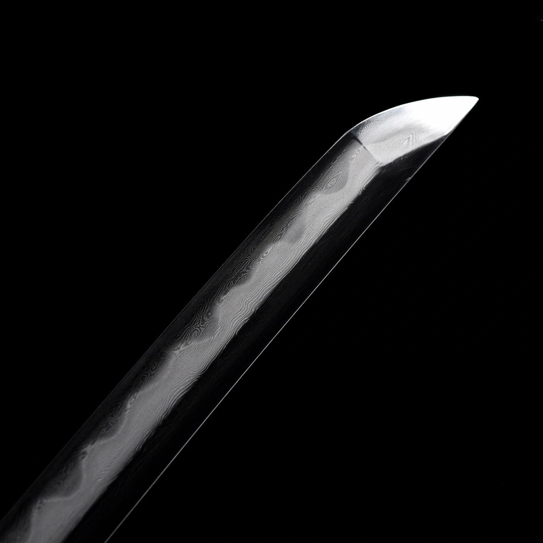 Precision polished Kissaki tip with distinct differential hardening Hamon line on Dragonheir Damascus Tachi sword