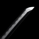 Precision polished Kissaki tip with distinct differential hardening Hamon line on Dragonheir Damascus Tachi sword