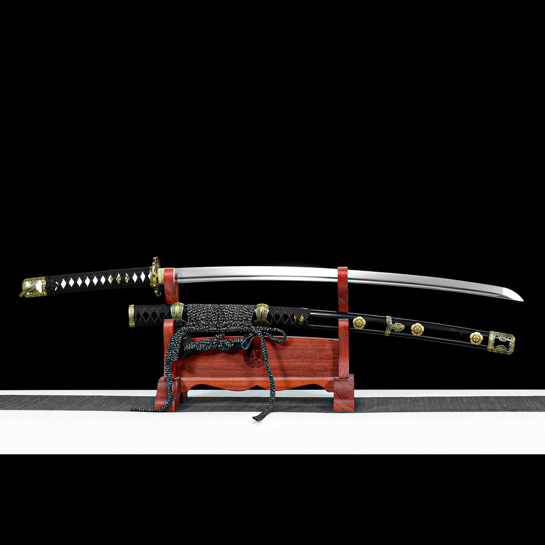 Unsheathed 1065 high carbon steel Murasame tachi sword blade resting above lacquered scabbard