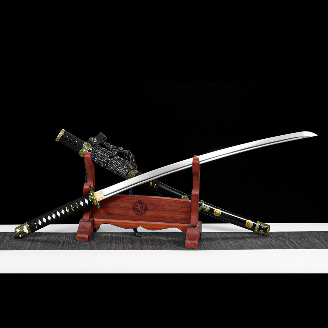Unsheathed hand-forged 1065 high carbon steel Murasame tachi sword blade parallel with scabbard on stand