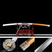 Overview collage of hand-forged tachi sword featuring orange scabbard white handle and silver fittings