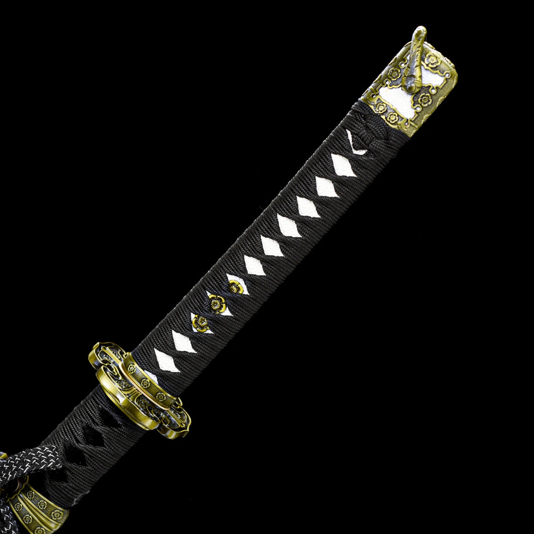 Close-up of black cotton tsuka wrap and intricate alloy sakura themed tsuba guard on Murasame tachi