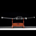 Fully sheathed Oblivion Fang hand-forged Damascus steel tachi sword displayed on wooden rack