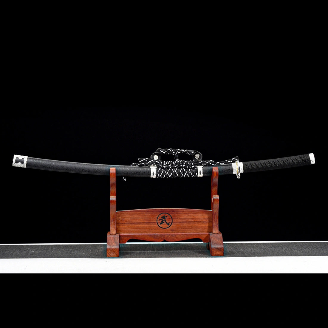 Fully sheathed Oblivion Fang hand-forged Damascus steel tachi sword displayed on wooden rack