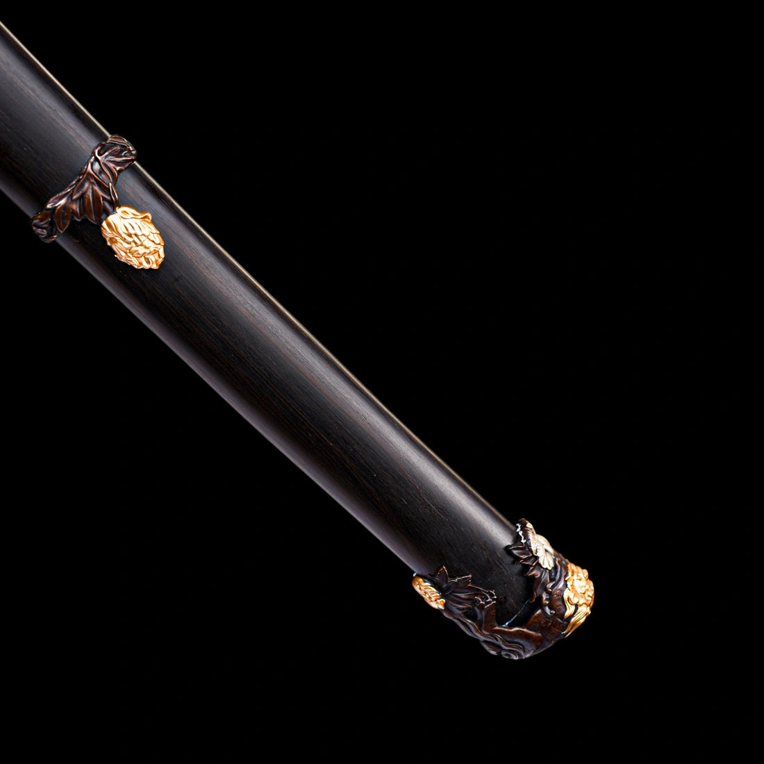Polished Brazilian ebony Saya scabbard featuring relief copper Kojiri end cap with hand-carved gold and silver lion inlays