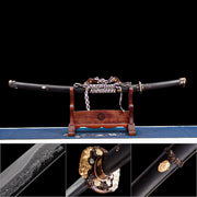 Sheathed Tyrantclaw Tachi in Brazilian ebony Saya on wooden stand with inset macro shots of dragon Horimono, gold-silver inlaid Tsuba, and Kojiri