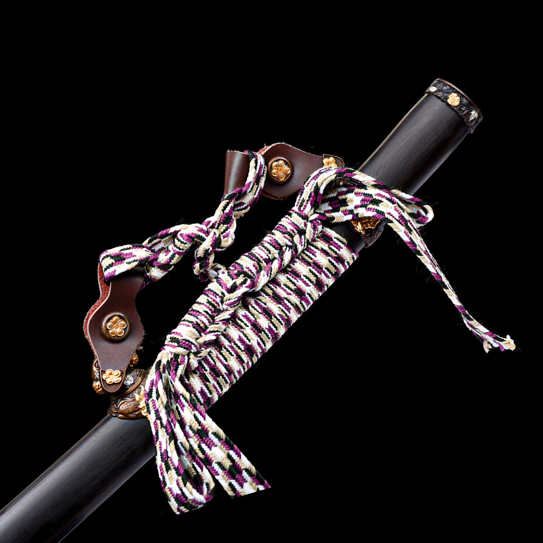 Close-up of leather Ashi suspension hangers with floral copper buttons and multi-color braided Sageo cord on ebony Saya